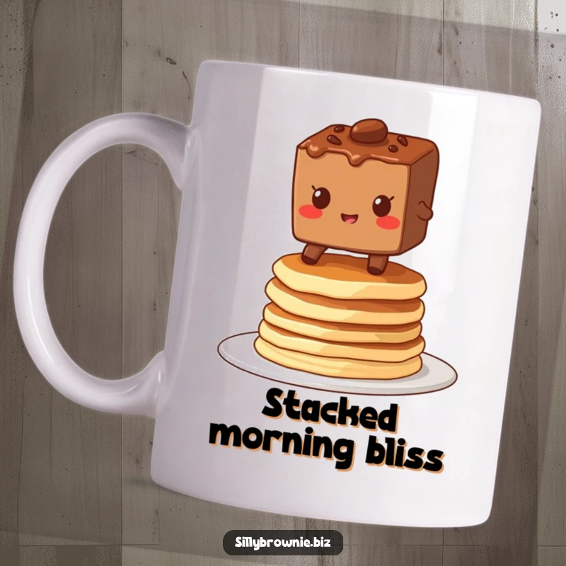 Funny mug featuring a brownie character grinning while balancing precariously on a stack of wobbly pancakes, showing delightful determination.