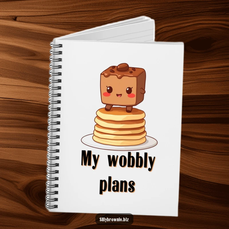 Funny notebook with a brownie character grinning while balancing on a stack of wobbly pancakes, great for jotting down breakfast thoughts.